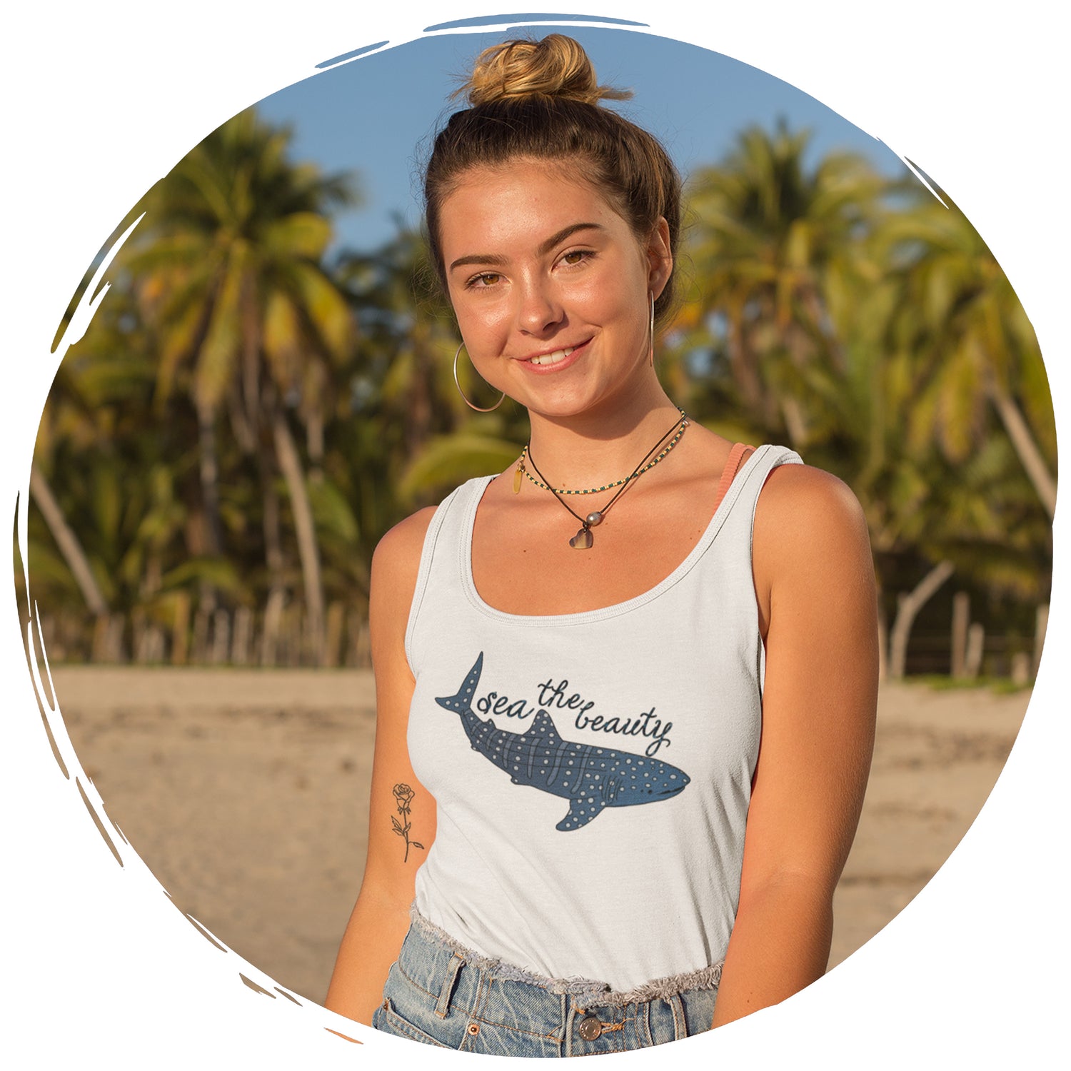 girl on beach with palm trees in background wearing Connected Clothing Company's Sea The Beauty Whale Shark Tank Top - Connected Clothing Company Brand Ambassador Program