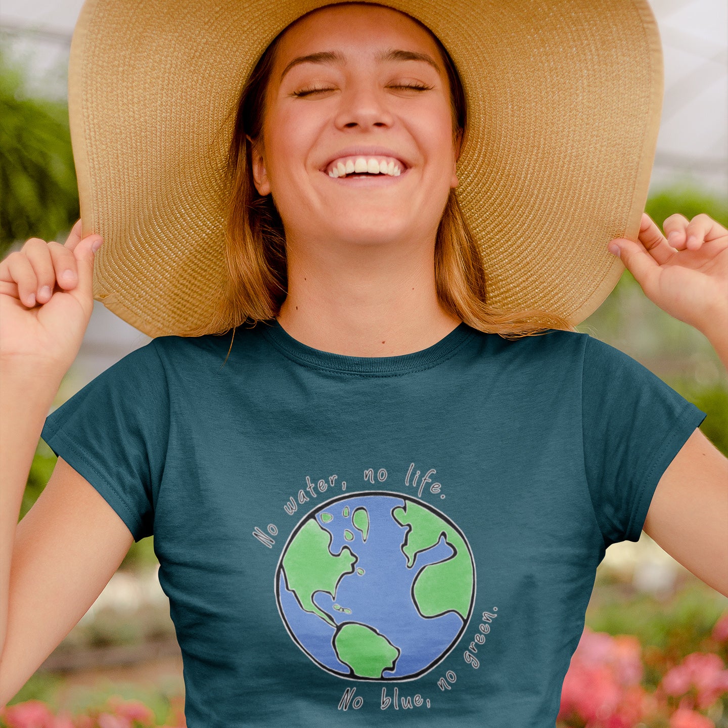 girl in greenhouse with flowers and sunhat wearing Connected Clothing Company "No Blue No Green" tshirt - 10% of profits give back to non-profit organizations - ethically and sustainably made clothing