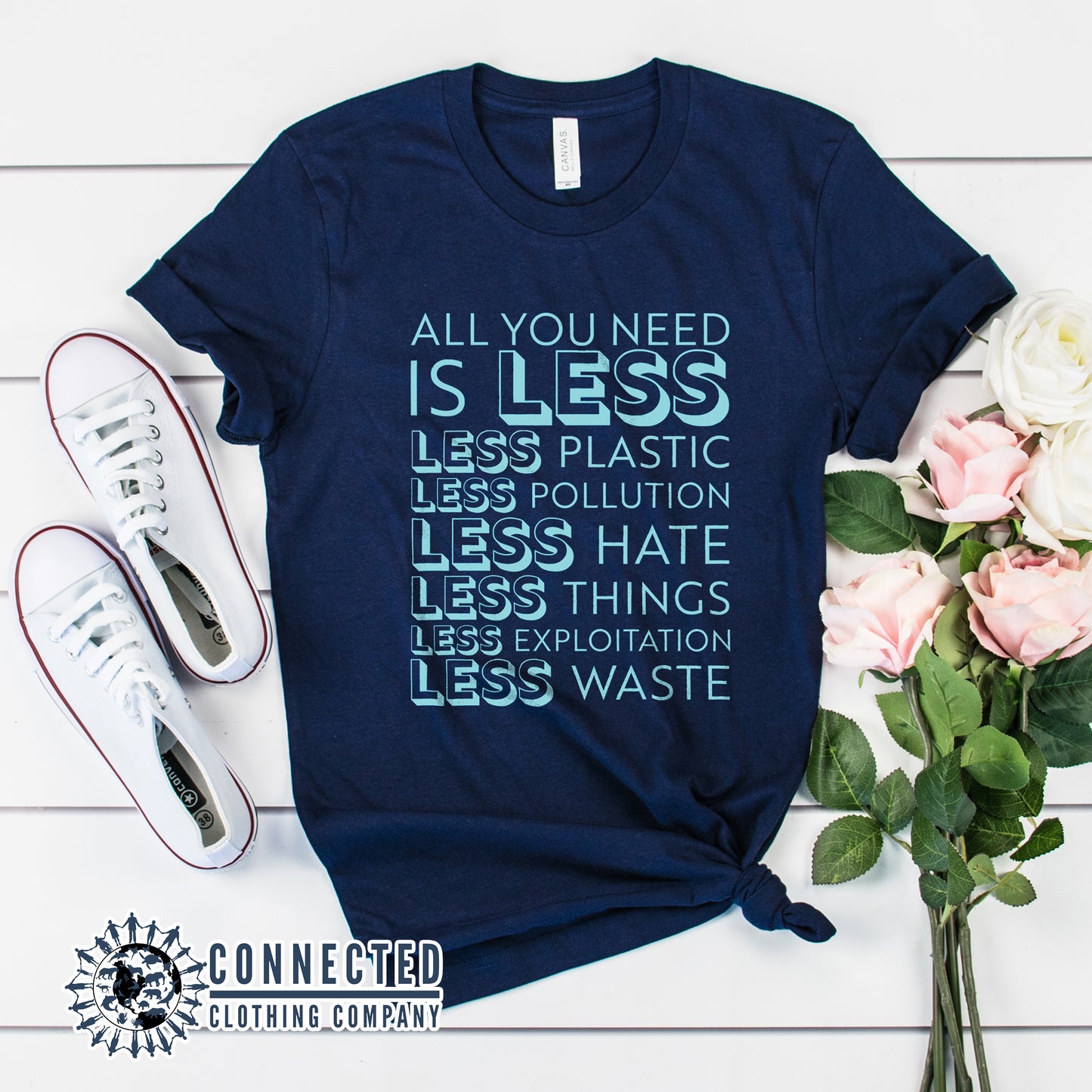 Navy Blue All You Need Is Less Short-Sleeve Unisex Tee reads "all you need is less. less plastic. less pollution. less hate. less things. less exploitation. less waste." - Connected Clothing Company - Ethically and Sustainably Made - 10% of profits donated to Mission Blue ocean conservation
