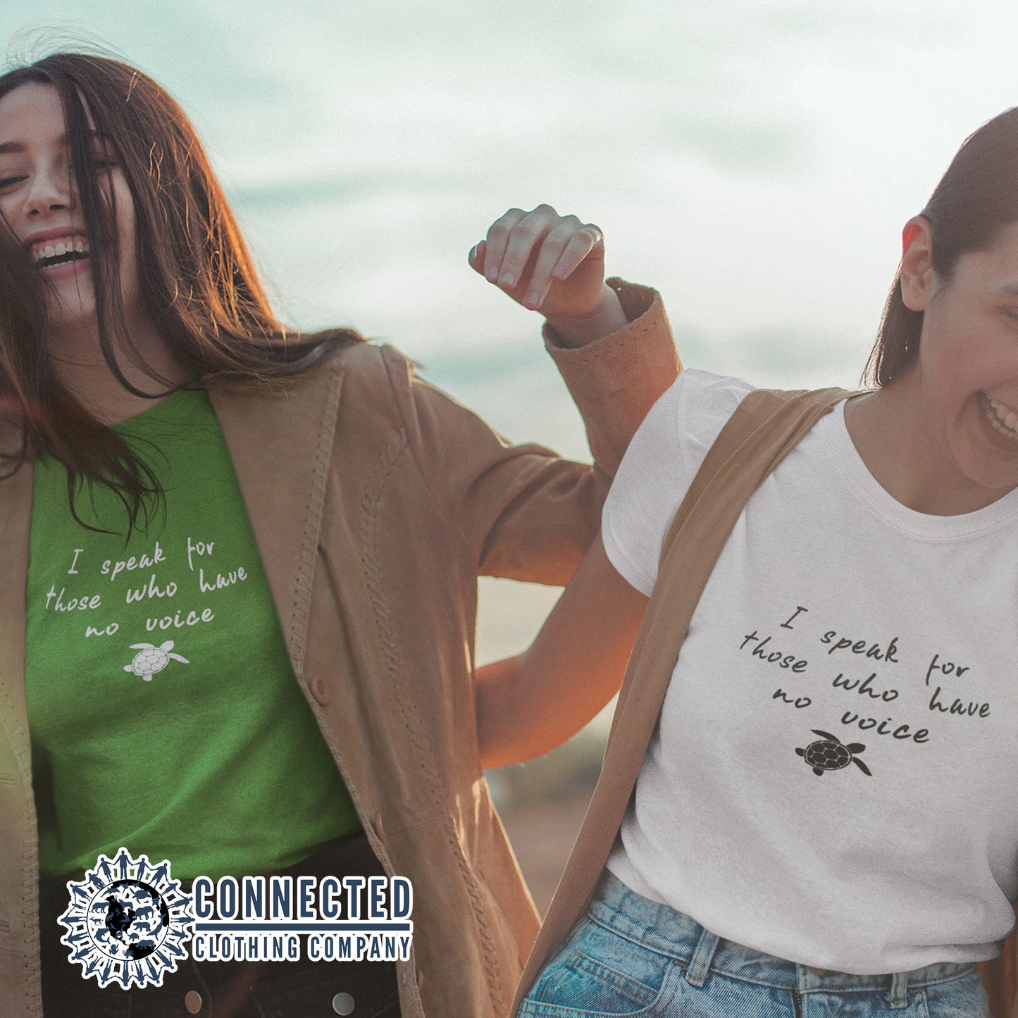 2 Friends Wearing A Kelly Green Be The Voice Sea Turtle Tee reads "I speak for those who have no voice." And A White Tee - Connected Clothing Company - Ethically and Sustainably Made - 10% donated to the Sea Turtle Conservancy