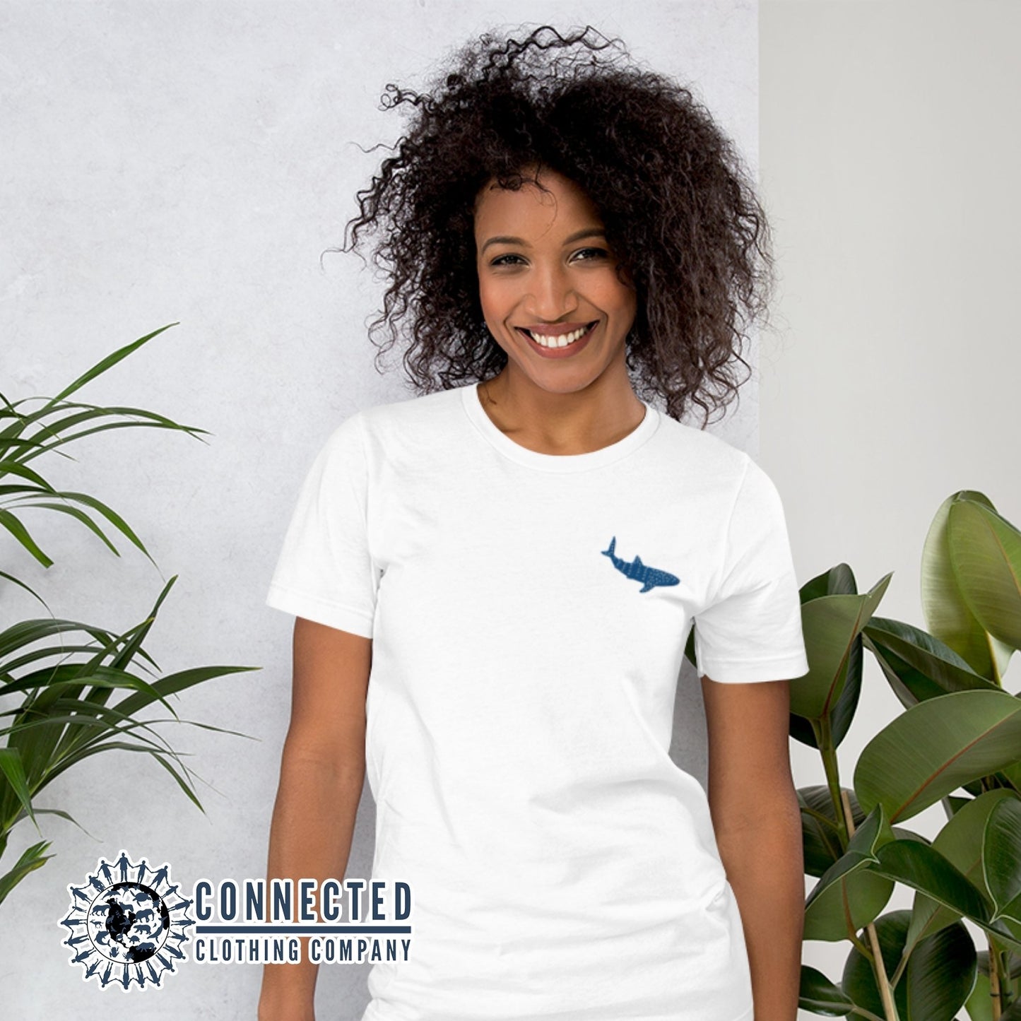 Model Wearing White Embroidered Whale Shark Short-Sleeve Shirt - Connected Clothing Company - Ethically and Sustainably Made - 10% of profits donated to shark conservation and ocean conservation