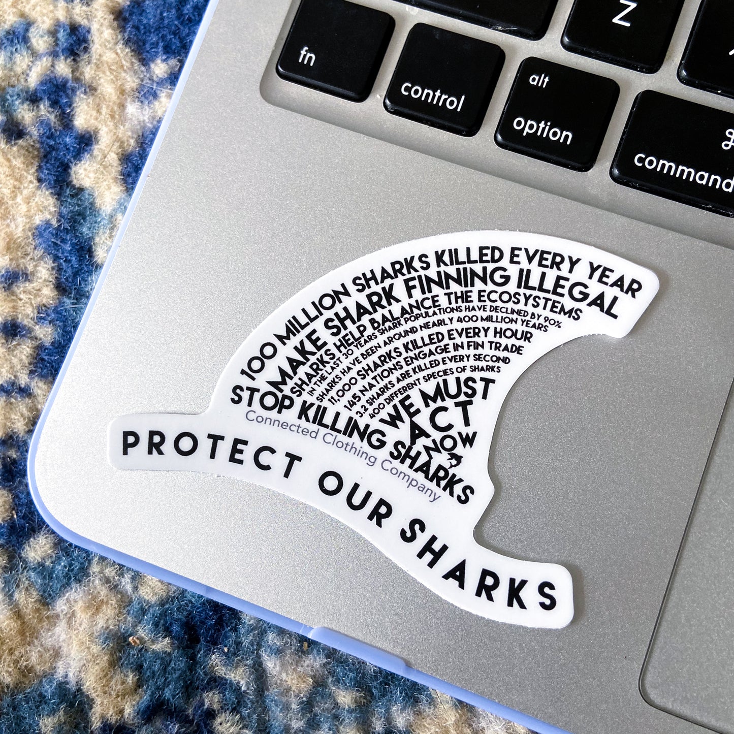 Connected Clothing Company Protect Our Sharks Sticker on Macbook for size reference.