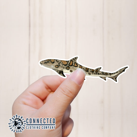 Hand Holding Leopard Shark Watercolor Sticker - Connected Clothing Company - Ethical and Sustainable Apparel - portion of profits donated to shark conservation