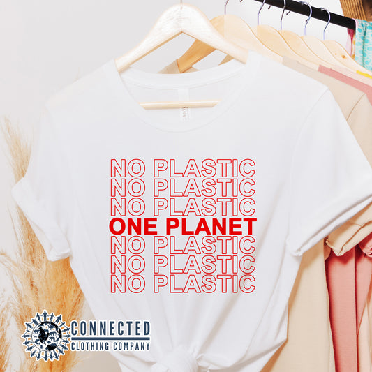 No Plastic One Planet Tshirt hanging on a clothing rack - Connected Clothing Company - Ethical and Sustainable Apparel - 10% of proceeds donated to ocean conservation