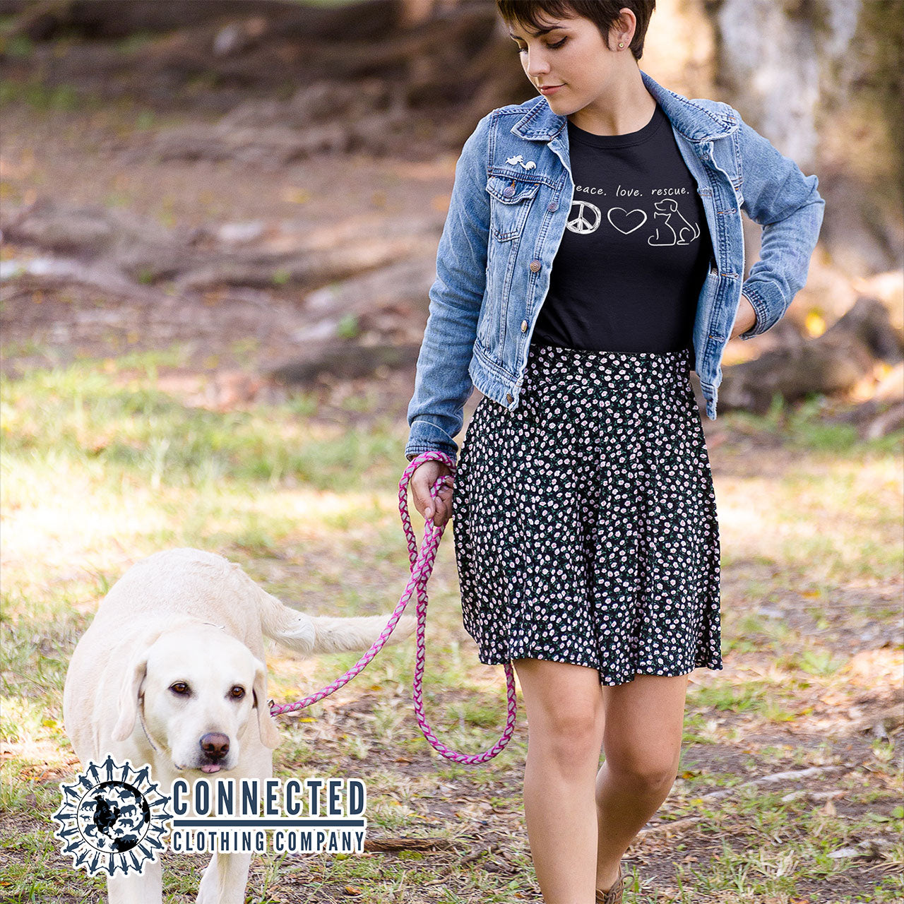 Model Walking Dog While Wearing Black Peace Love Rescue Short-Sleeve Tee - Connected Clothing Company - Ethically and Sustainably Made - 10% donated to Villalobos Animal Rescue Center