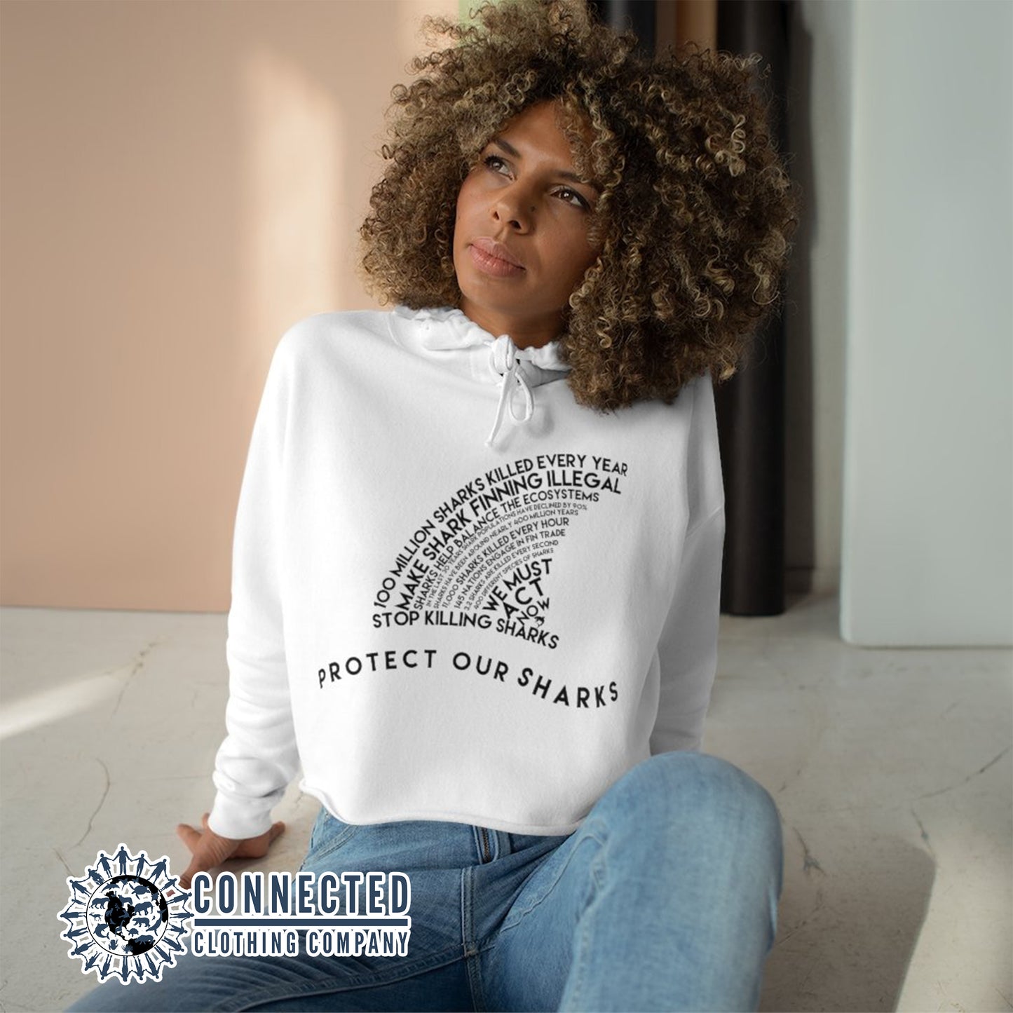 Model Wearing White Protect Our Sharks Crop Hoodie - Connected Clothing Company - Ethically and Sustainably Made - 10% of profits donated to shark conservation and ocean conservation