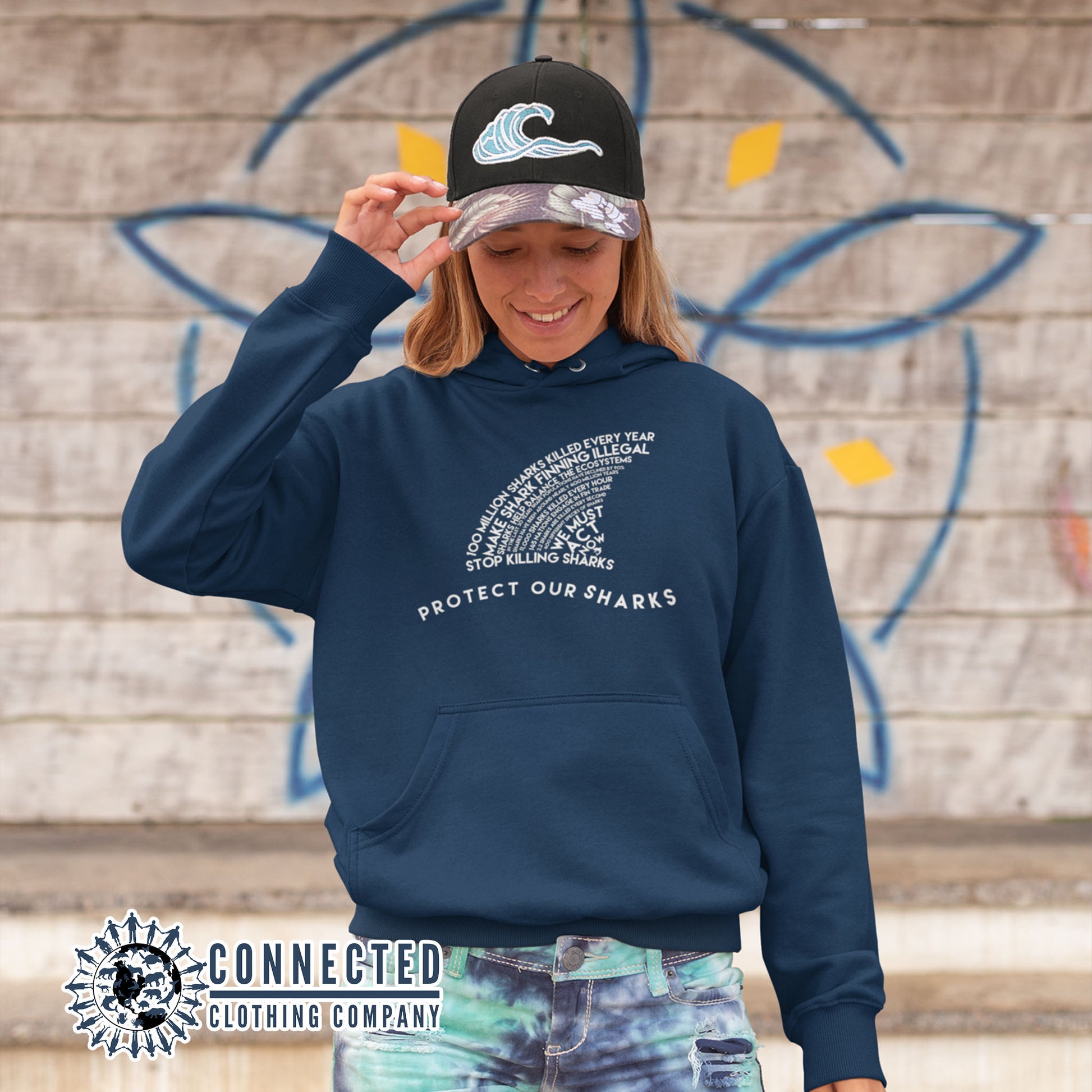 Model Wearing Navy Protect Our Sharks Unisex Hoodie - Connected Clothing Company - Ethically and Sustainably Made - 10% donated to Oceana shark conservation