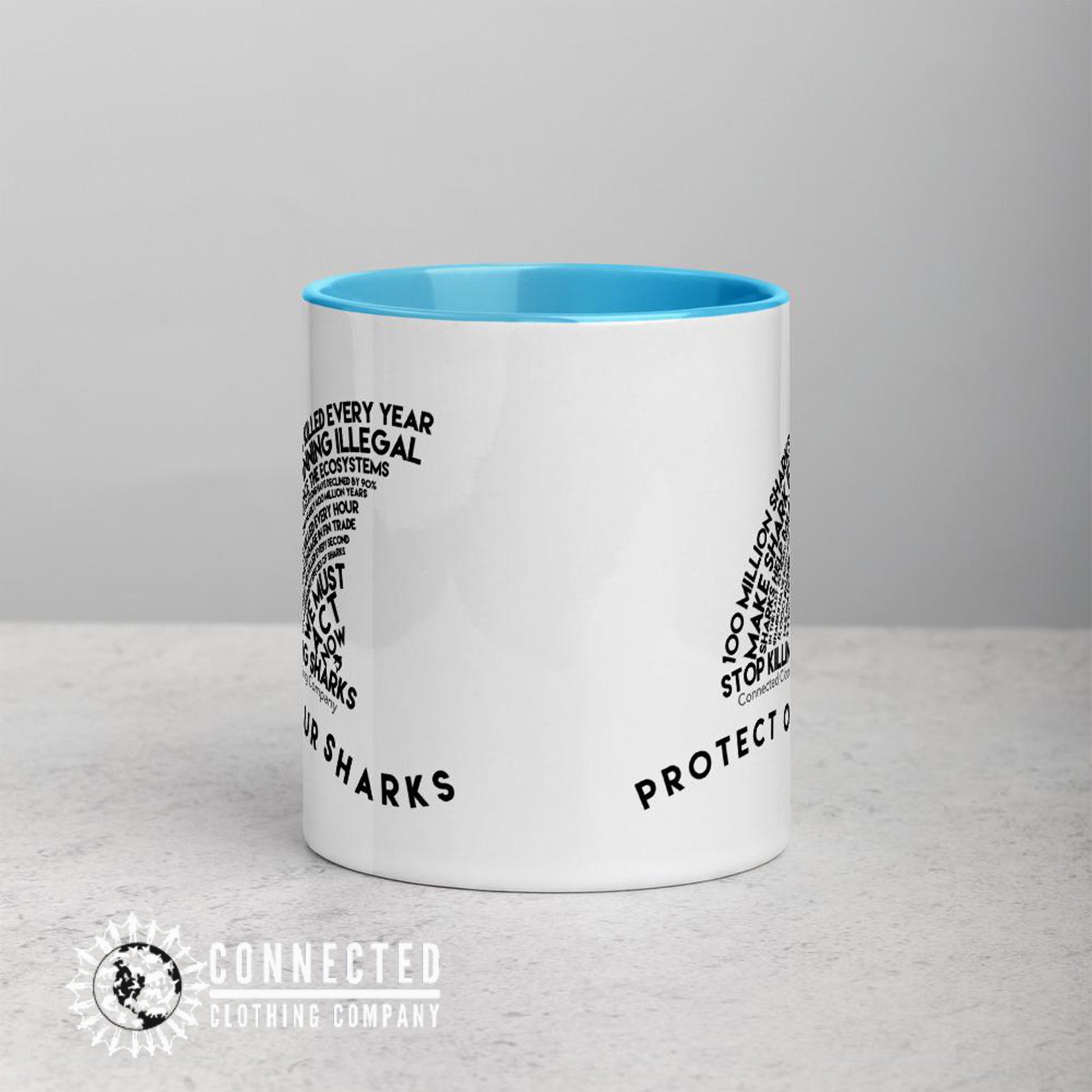 Front Side of Protect Our Sharks Mug With Blue Coloring on Inside, Rim, and Handle - Connected Clothing Company - Ethically and Sustainably Made - 10% donated to Oceana shark conservation
