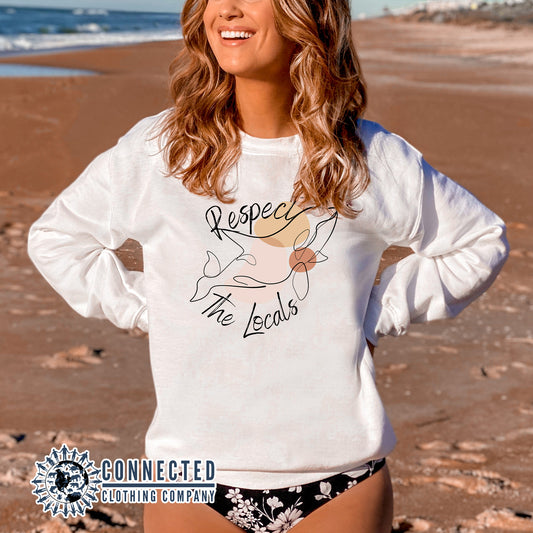 Model Wearing White Respect The Locals Orca Unisex Crewneck Sweatshirt - Connected Clothing Company - Ethically and Sustainably Made - 10% of profits donated to ocean conservation