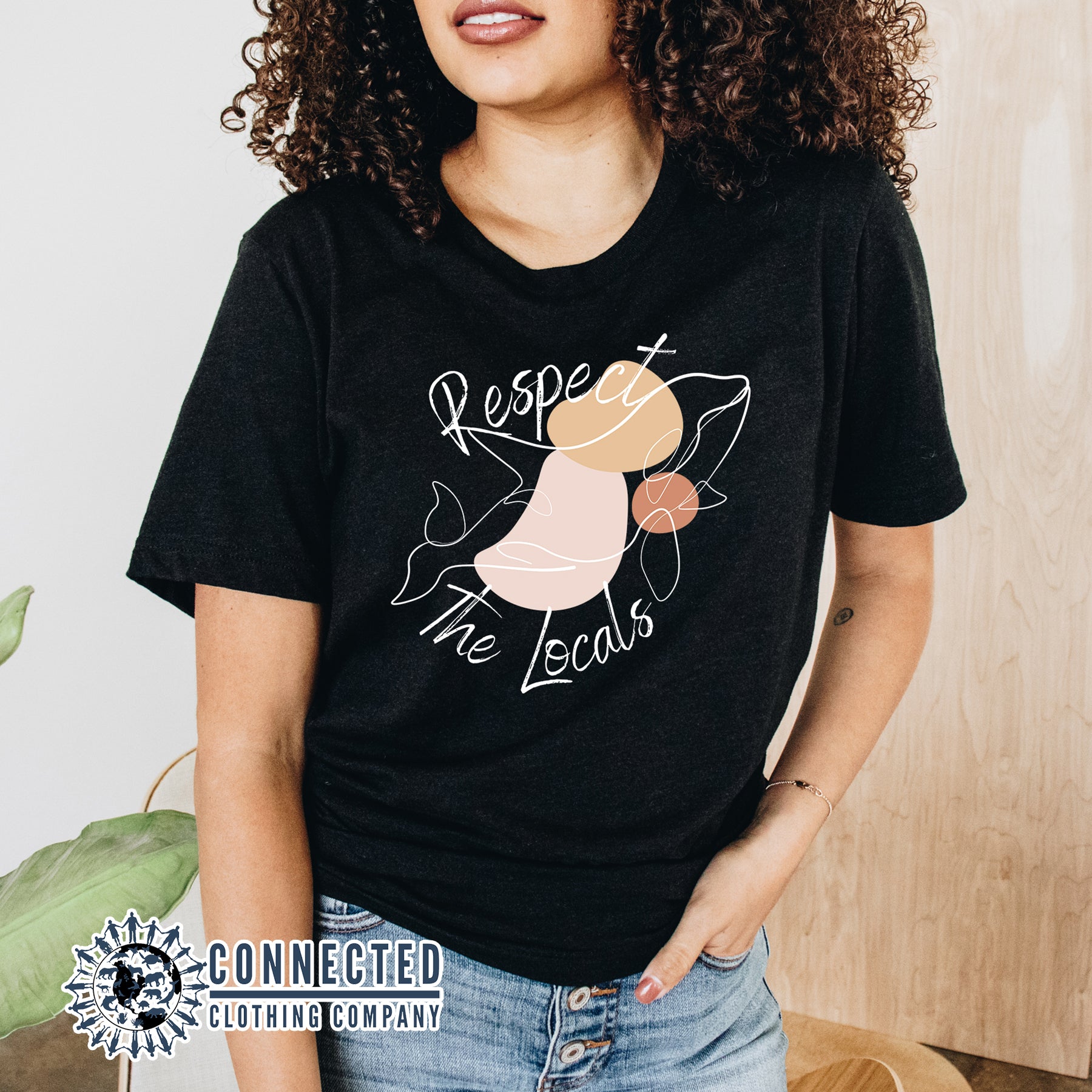  Model Wearing Black Respect The Locals Orca Unisex Short-Sleeve Tee - Connected Clothing Company - Ethically and Sustainably Made - 10% of profits donated to orca conservation