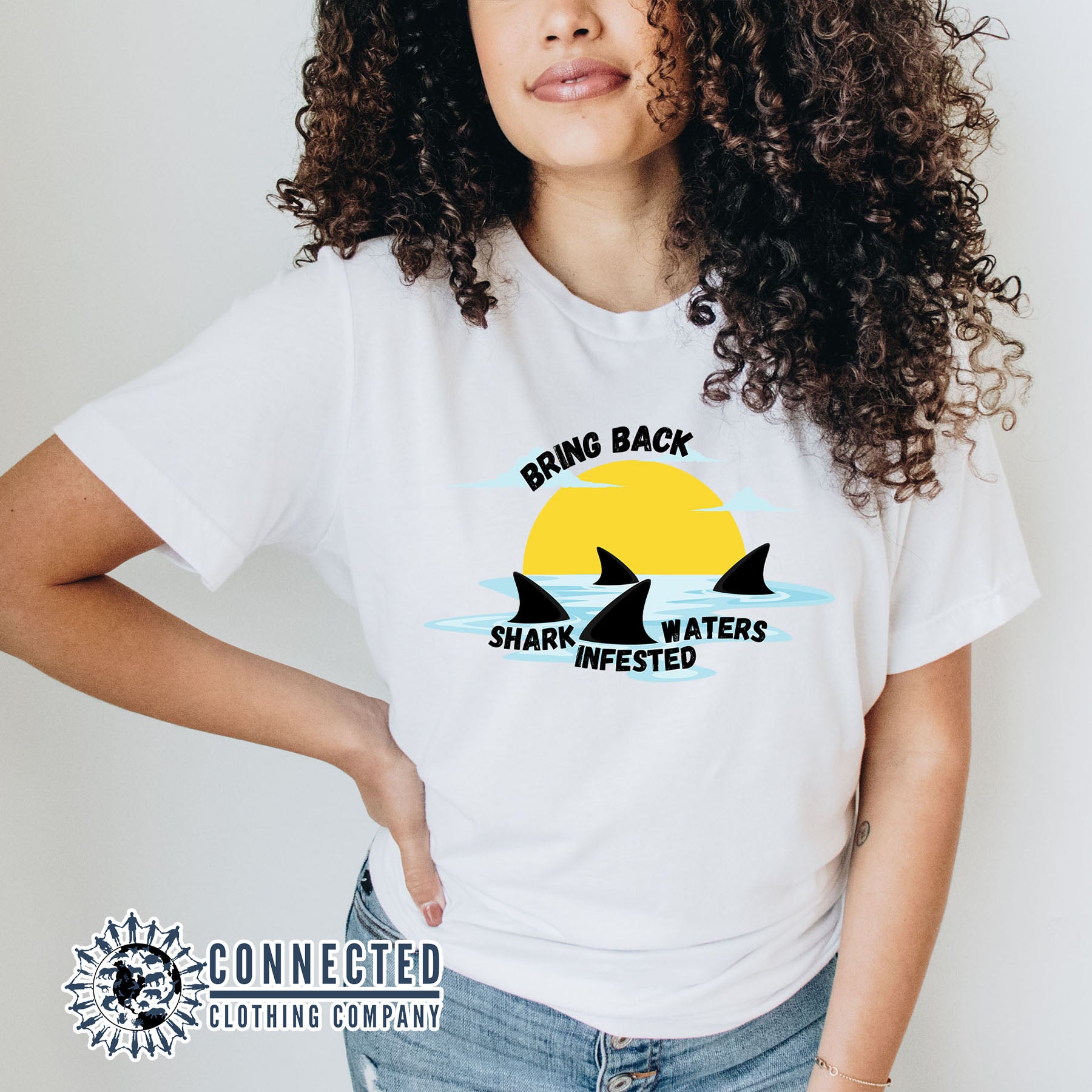 Model Wearing White Bring Back Shark Infested Waters Unisex Short-Sleeve Tee - Connected Clothing Company - Ethically and Sustainably Made - 10% of profits donated to shark conservation and ocean conservation
