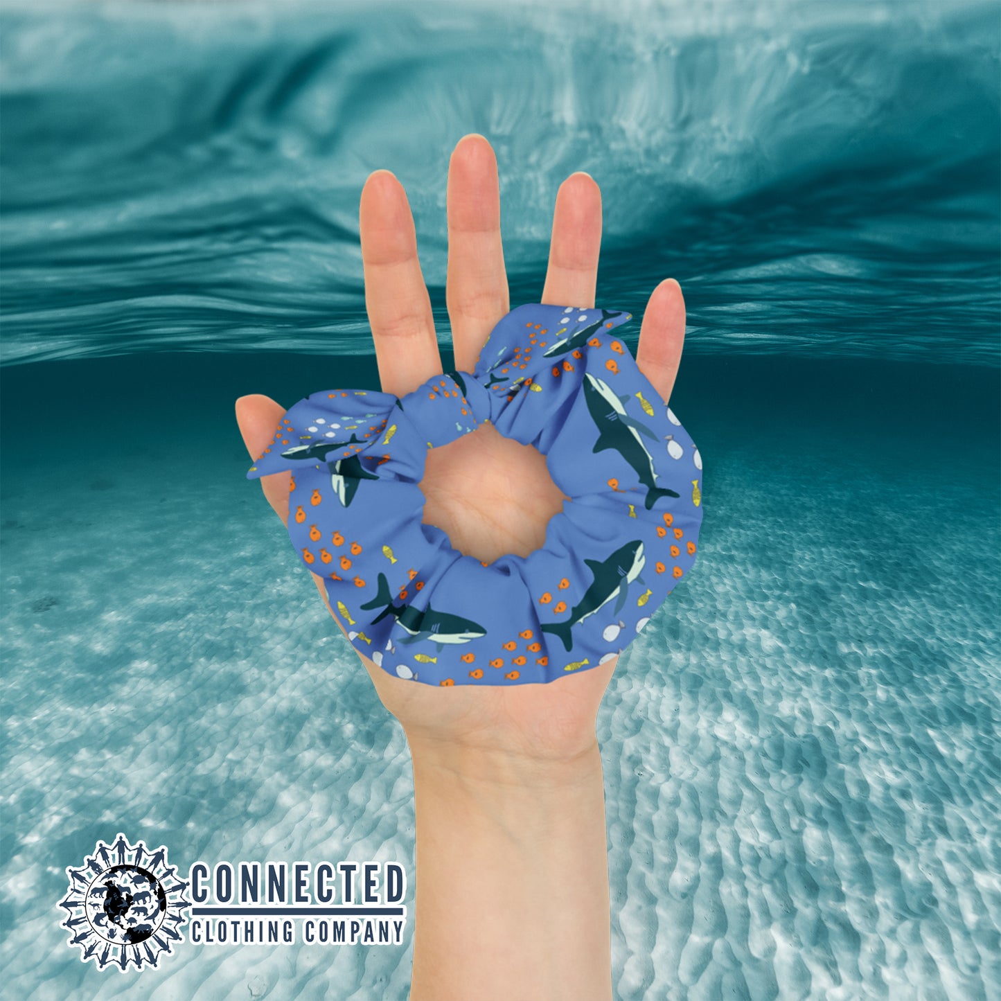 Hand Holding Shark Scrunchie in Dark Color - Connected Clothing Company - Ethical & Sustainable Apparel - 10% donated to save the sharks
