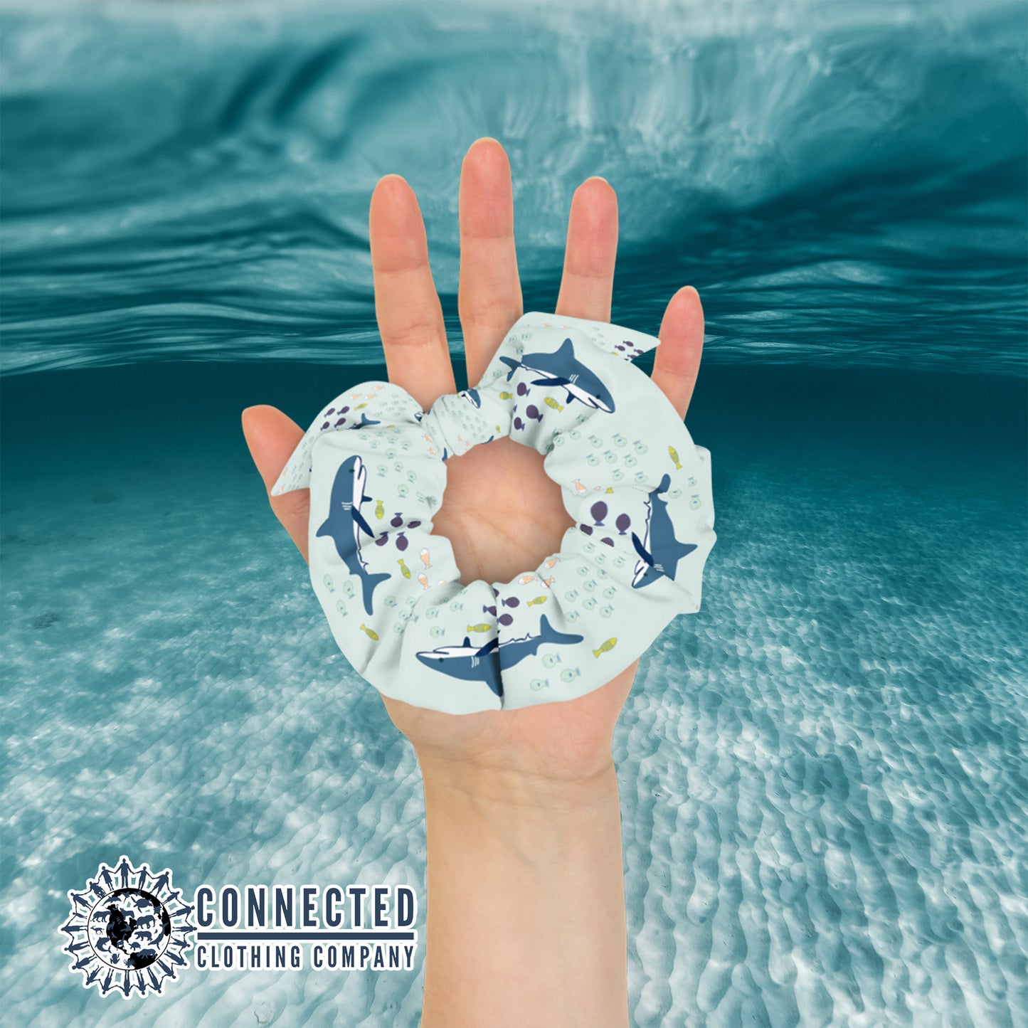 Hand Holding Shark Scrunchie in Light Color - Connected Clothing Company - Ethical & Sustainable Apparel - 10% donated to save the sharks