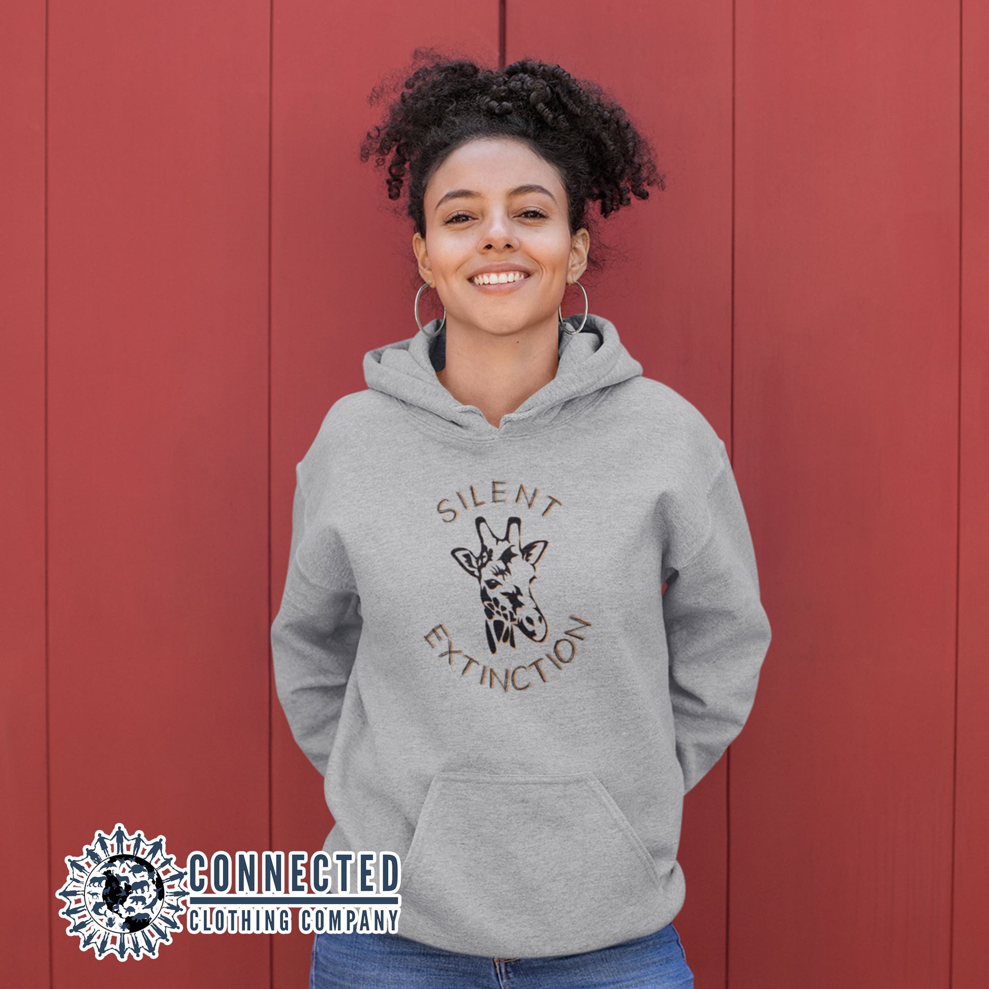 Model wearing Carbon Grey Giraffe Silent Extinction Unisex Hoodie - Connected Clothing Company - 10% of profits donated to the Giraffe Conservation Foundation