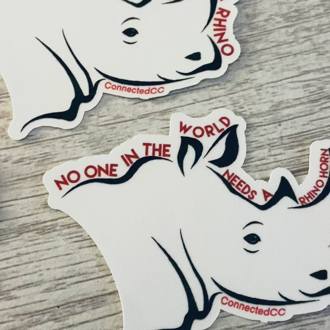 White No One Needs A Rhino Horn Sticker reads "No One In The World Needs A Rhino Horn Except A Rhino" - Connected Clothing Company - Ethically and Sustainably Made - 10% donated to Save The Rhino International