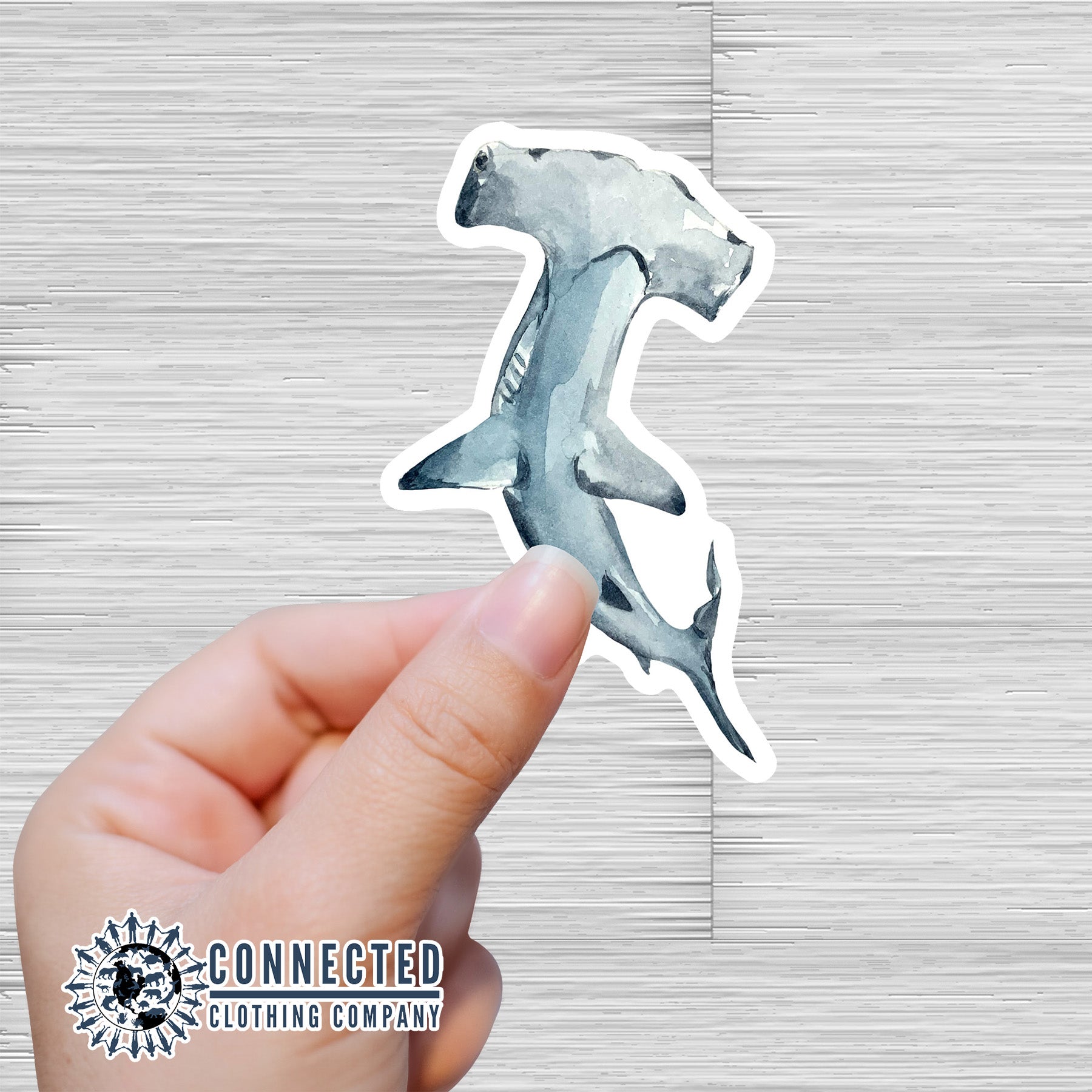 Hand Holding Hammerhead Shark Watercolor Sticker - Connected Clothing Company - Ethical and Sustainable Apparel - portion of profits donated to shark conservation